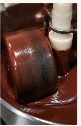 Chocolate being refined in a melanger-style process
